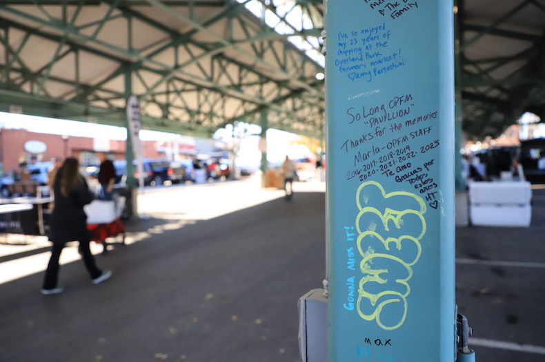 Patrons and vendors alike bid farewell to the Overland Park Farmers' Market pavilion in downtown Overland Park this weekend by leaving messages on the pillars. The structure is headed southwest to Garnett, Kansas, making way for a new indoor and outdoor pavilion space.