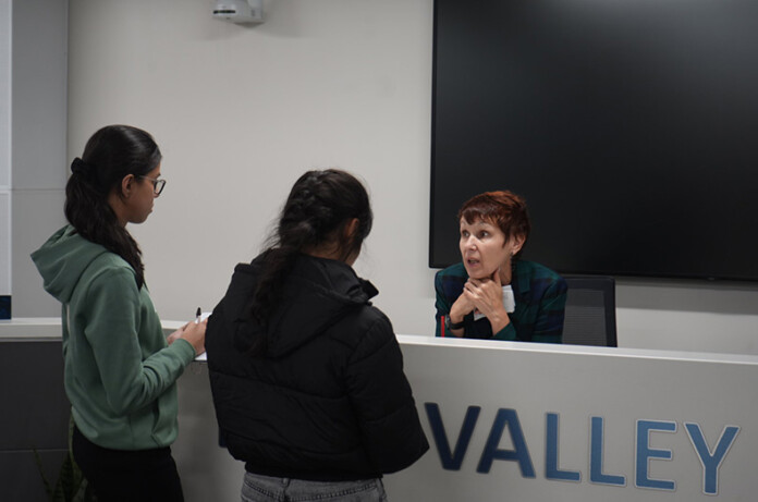 Blue Valley Superintendent Tonya Merrigan (right) 333explains the superintendent search process to two Blue Valley North students.