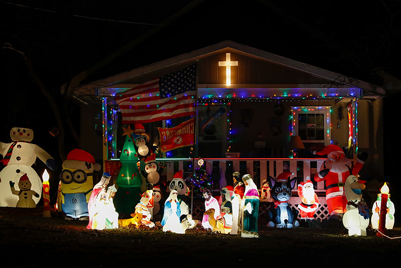 Christmas theme inflatables, a Nativity set and flags outside of a home on Knox Avenue and West 53rd Street in Merriam.