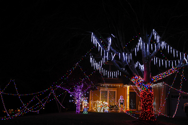 Colorful lights hand from trees outside of a home on Benson Street and 123rd Terrace in Overland Park.