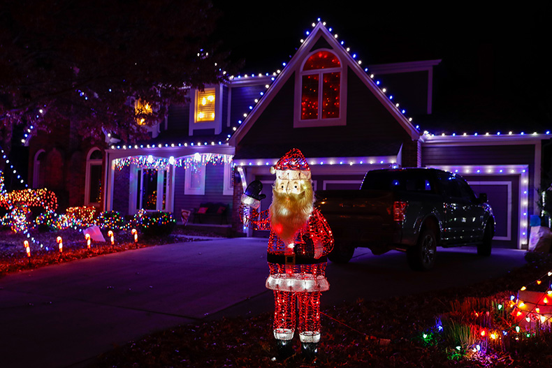 A light-up Santa waves from a home in the “Christmas Place” neighborhood at West 131st Place and Antioch Road in Overland Park.