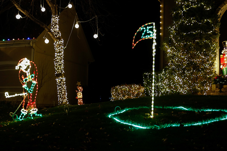 A light-up Santa plays golf in front of a home in the “Christmas Place” neighborhood at 131st Place and Antioch Road in Overland Park.