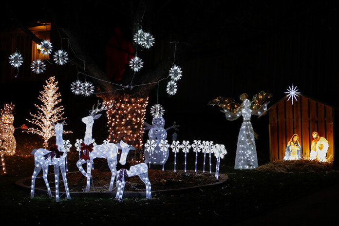 Light-up deer and a Nativity scene are seen outside of a home located on West 103rd and Nolan Road.