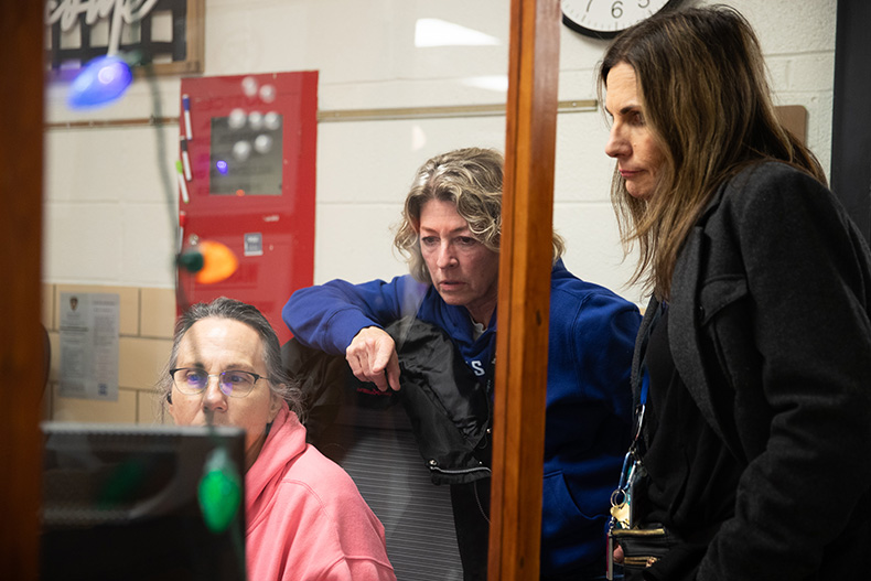 Project 1020 co-founder Barb McEver (center) works with volunteers at the Lenexa shelter.