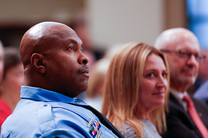 Sheriff Byron Roberson (left) sits by his wife, Stacy Roberson, during his swearing-in ceremony on Monday, Jan. 13, at the Johnson County Administration Building in Olathe.