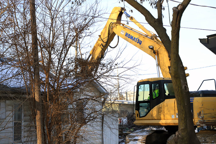 An excavator begins demolishing the house at 413 S. Cherry Street in downtown Olathe.