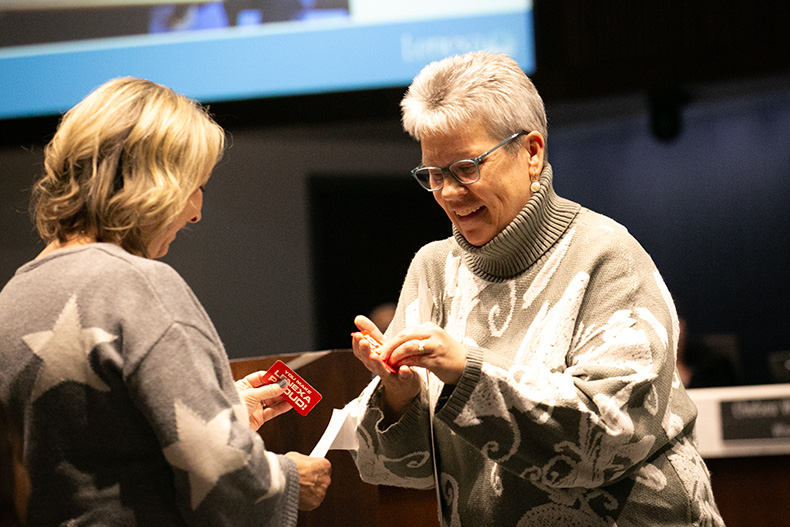 Former councilmember Mandy Stuke (right), gave Lenexa hype/pride magnets to Amy Karlin and the rest of the late Joe Karlin's family.