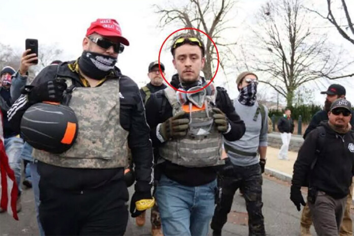 The government's criminal complaint against Ryan Ashlock identifies him as the figure on the right in this photograph.