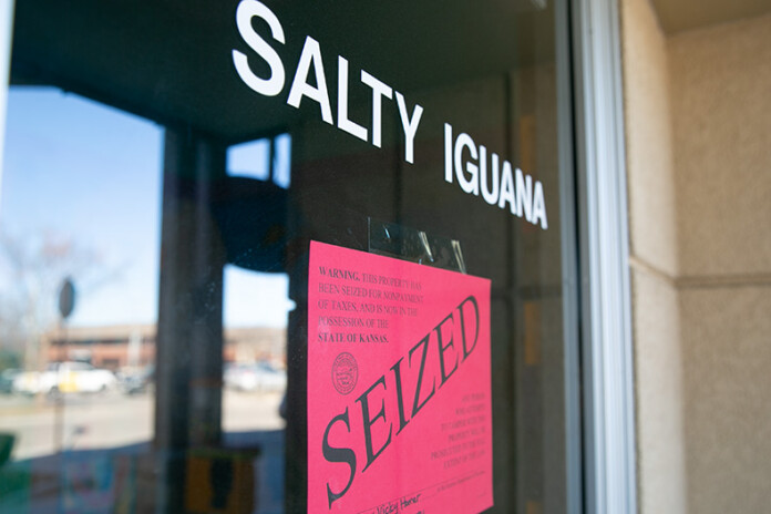 A seized sign on the front door of Salty Iguana in Prairie Village