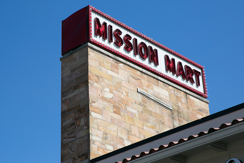 An existing Mission Mart sign, before a new sales tax goes into effect on July 1.