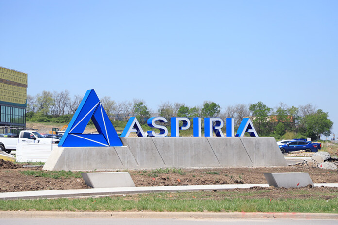 The new monument sign off for Aspiria off of Nall Avenue. Behind the sign, a new entertainment complex is under construction.