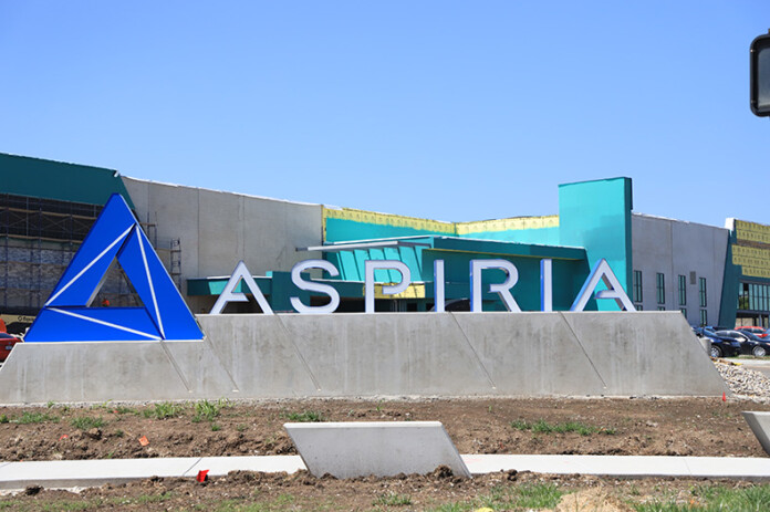 The new monument sign off for Aspiria off of Nall Avenue. Behind the sign, a new entertainment complex is under construction.