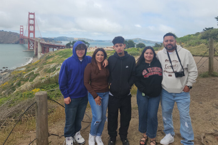 A family photo of Evenezer Cortez Martinez, pictured on the far right, with his wife and children. The Roeland Park family is now awaiting a federal lawsuit filed on his behalf. Despite having DACA status and permission to travel, the husband and father was detained, deported and denied entry back to the U.S. after a trip to Mexico.