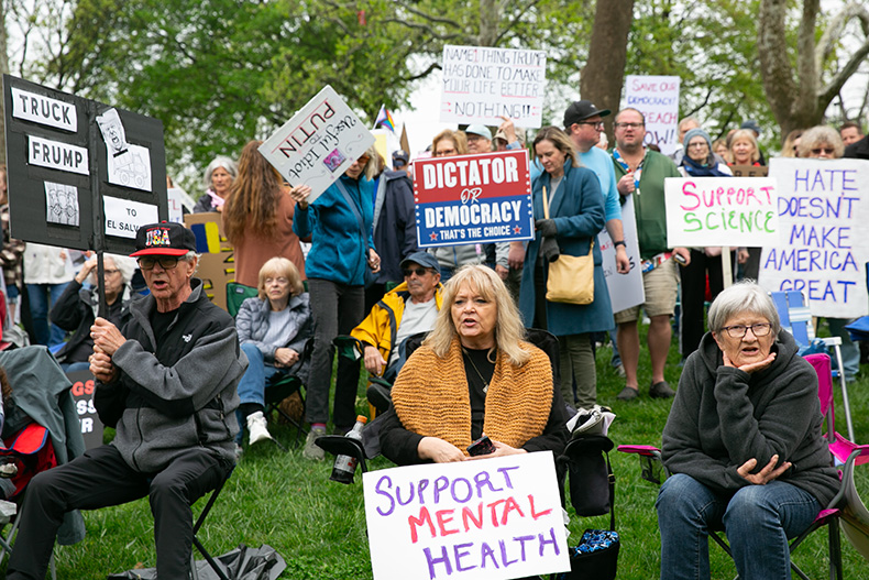 Protestors chant "Hey hey, ho ho, Donald Trump has got to go" at an Overland Park protest. 