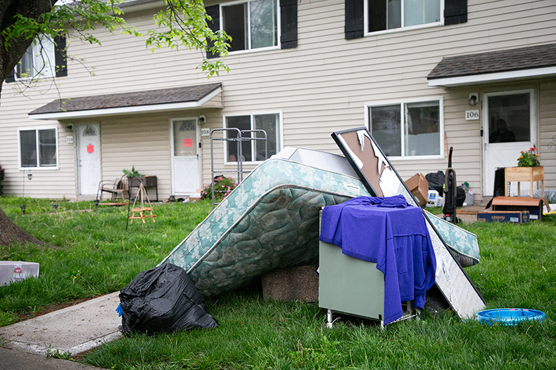 Furniture is stacked up on the front lawns as tenants quickly emptied their homes.