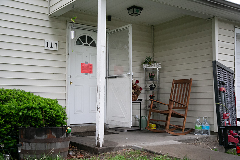 Many apartments and houses in Aspen Place still had homey touches like this one with a rocking chair, welcome sign and flower pots.