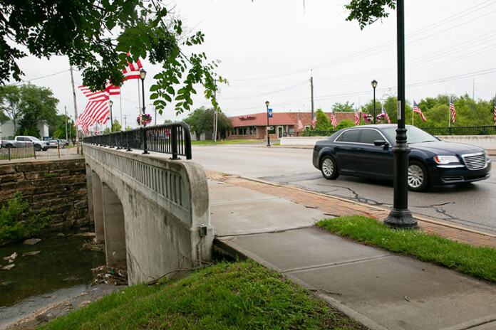 A car heads south on the Merriam Drive bridge