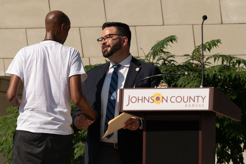 Steven Arledge (left), shakes hands with County Chairman Mike Kelly as he prepares to speak. “Even in our darkest times, there is light that shines with a vision for the future to which we can all aspire,” Kelly said in his remarks.