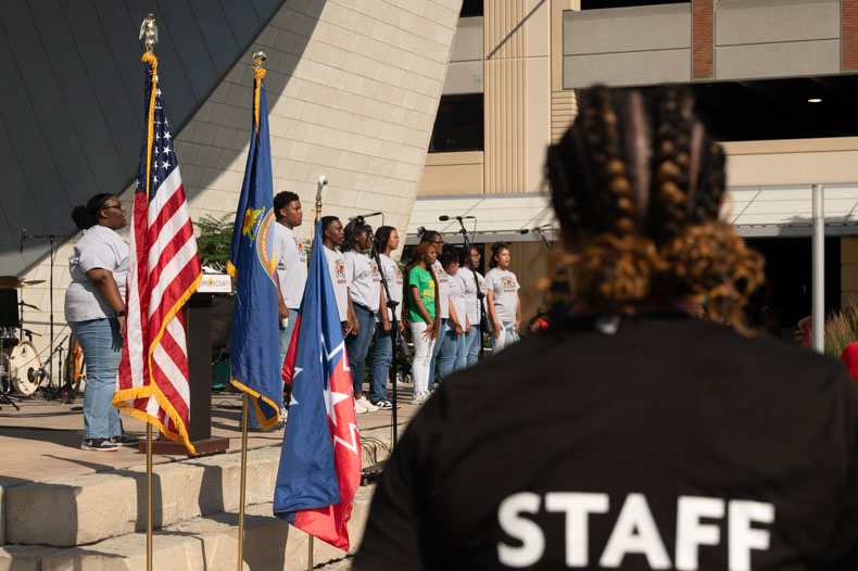 Winter Arledge watches on as the Kansas City Boys and Girls Choir sings “I’ll Be There”. Arledge was a leading member of the Juneteenth Planning Committee and is Program Manager of Johnson County Developmental Supports.