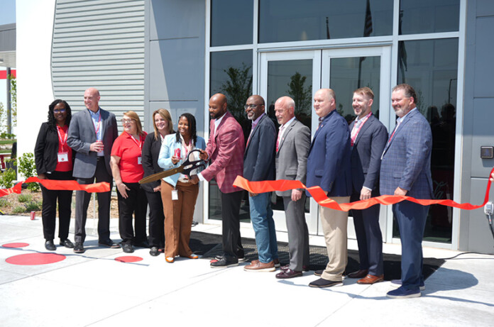 Justin Bridgeman, CEO of Heartland Coca-Cola, cuts the ribbon Tuesday to celebrate the grand opening of the company's new production campus in Olathe.