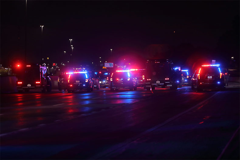 Numerous police vehicles from several local agencies on the scene of a standoff on northbound I-35 on Thursday, June 12. 