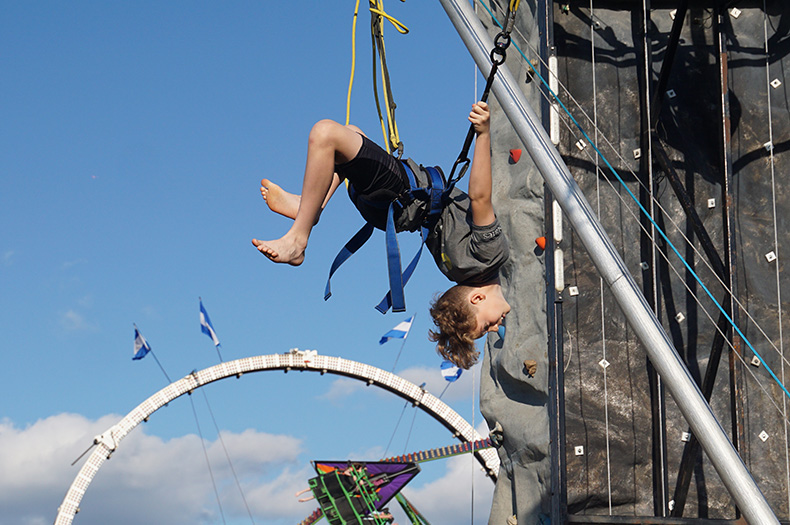A kid does a flip on one of the attractions at Old Shawnee Days. Photo credit Andrew Gaug.