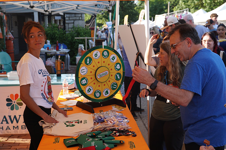 People spin the wheel at Nathan's Hot Dog stand to win prizes. Photo credit Andrew Gaug.