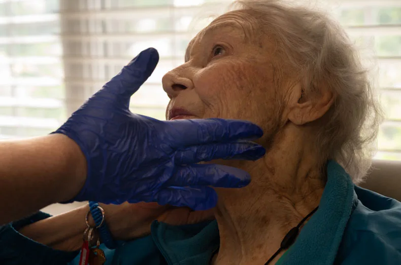 Patricia receives a careful touch of blush to complement her lipstick.