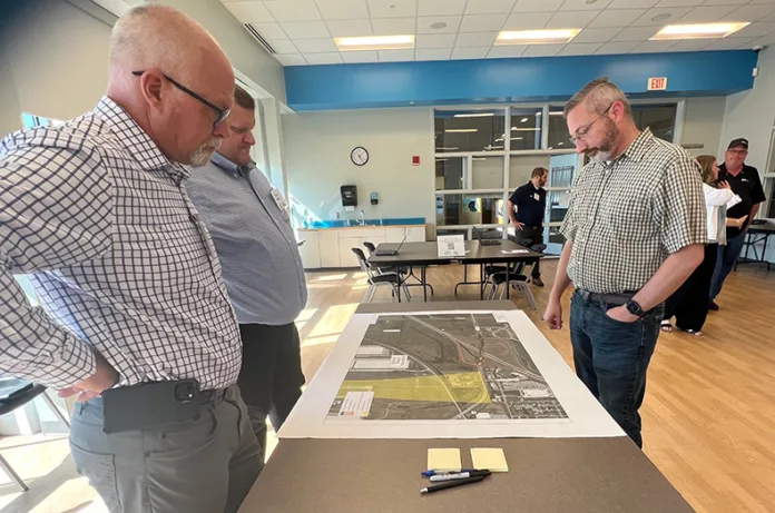 Gardner Public Works Director Kellen Headlee (right) shared his concerns with KDOT engineers about the safety of the third design for the 175th St/U.S. 56/I-35 interchange project at an open house July 1.