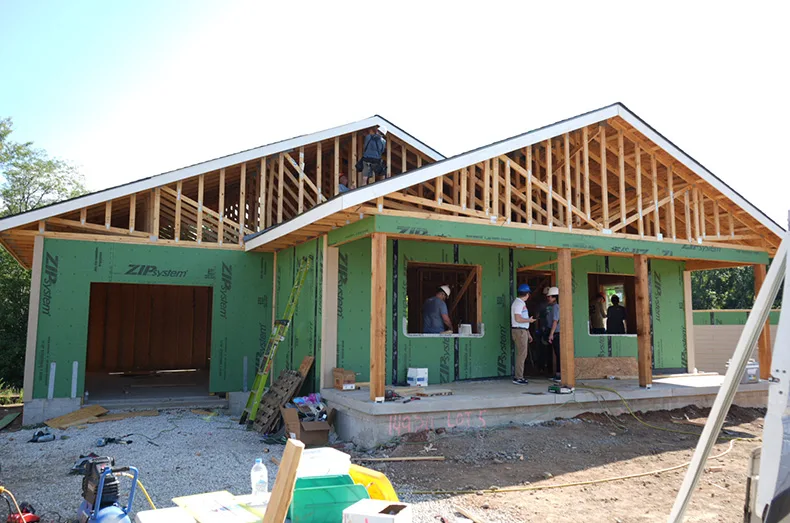 Employees from Kansas City-based Foundation Recovery Systems, which offers home repair solutions, volunteered Tuesday at the Habitat project, near 159th Street and Black Bob Road.