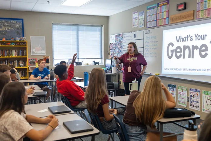 A student raises his hand to share in Lorette McKedy’s eighth-grade English language arts class at Pioneer Ridge Middle School in Gardner.