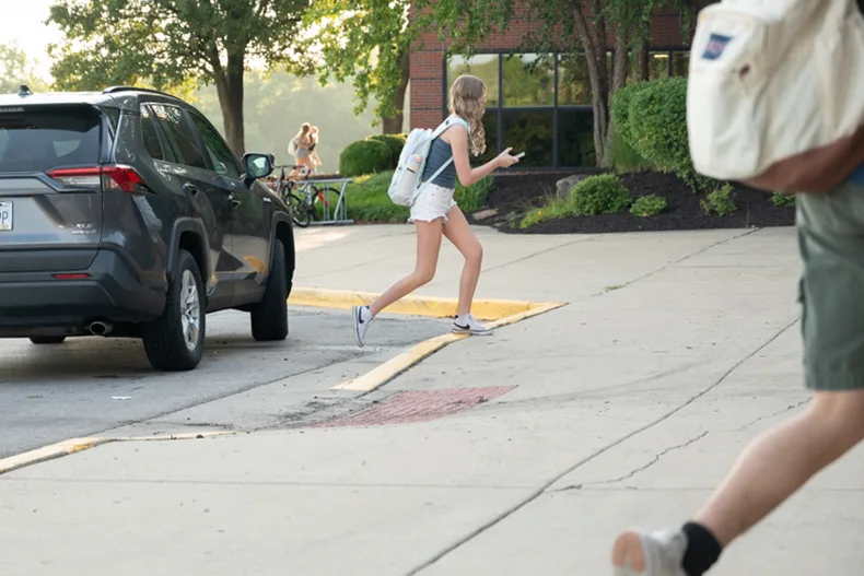 Students are dropped off or walk from the parking lot to Olathe East.