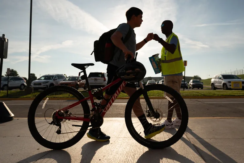 Robert Mitchell gives a fist bump and fruit snacks to a student at California Trail Middle School. Mitchell is a part of Father’s Club, an organization based in Kansas and Missouri that encourages fathers to get involved in supporting local students and educators.