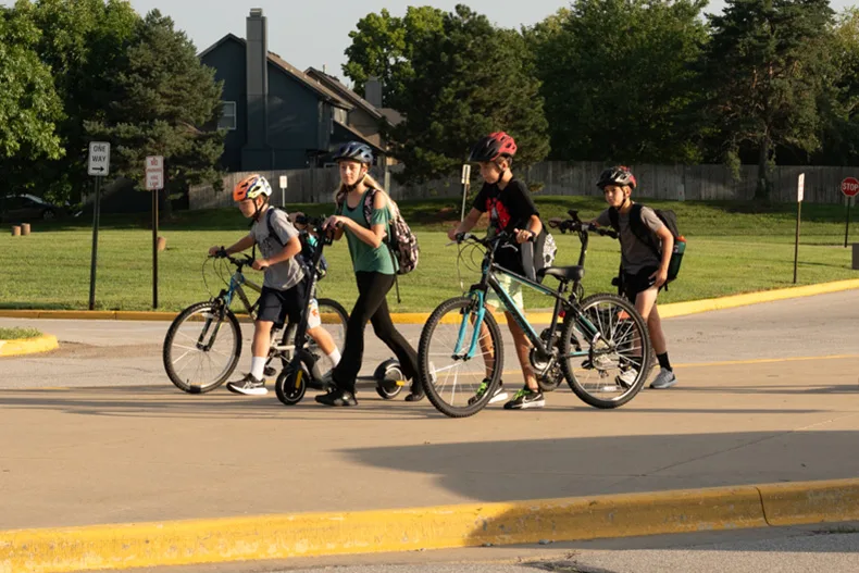 A group of California Trail students walk the last stretch of their rides to school.