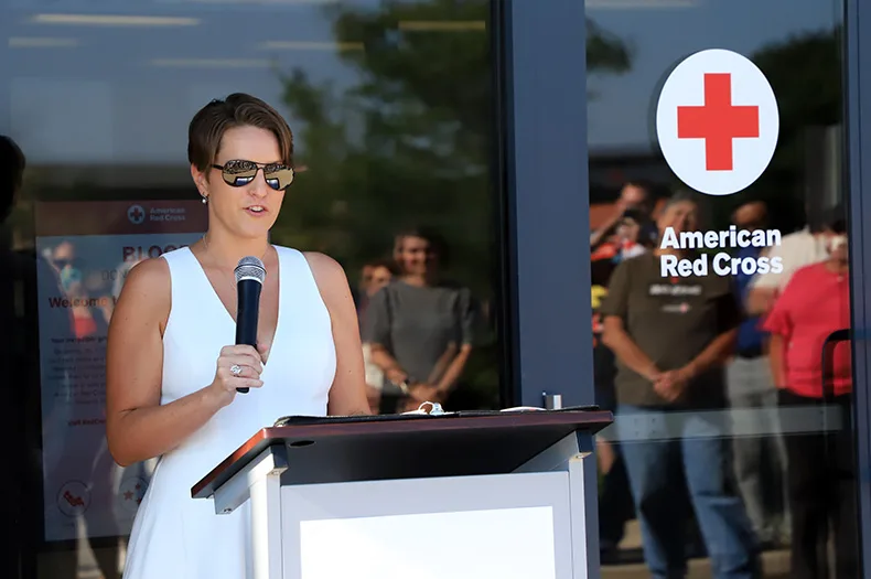 Meghan Jolliffe's life was saved by donated blood seven years ago after suffering a rare pregnancy complication. On Tuesday, she helped celebrate the opening of a new Red Cross blood donation center in Overland Park by sharing her story.