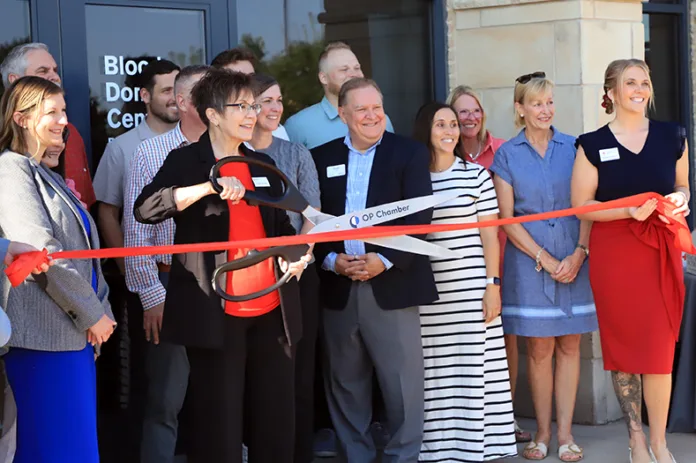 Red Cross officials and Overland Park Chamber of Commerce members celebrated the official opening of the first Red Cross fixed donation center in the KC area.