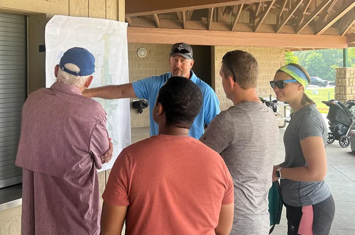 Kelby Hellwig, a regional park manager with Johnson County Park and Recreation District, talks to residents at the Kill Creek Park open house on Saturday.