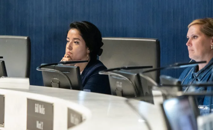 Lenexa City Council member Melanie Arroyo, left, listens to public comments during an Aug. 19, 2025, city council meeting.