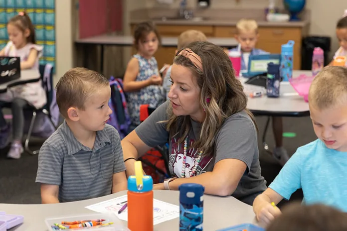 Natalie Nelson speaks with one of her kindergarteners on the first day of school at Madison Elementary on Aug. 13.