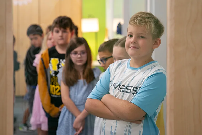 A student smiles on the first day of school 2025. 