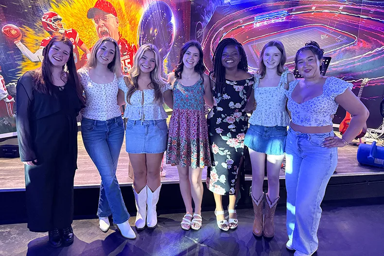 Fellow seniors and performers celebrated after the Songwriting Showcase. From left: Amelia Hooper, Mabel Craig, Emma Crosier, Taryn Dale, Dannon Mwangi, Brooke Gunter, and Anna Schumacher.