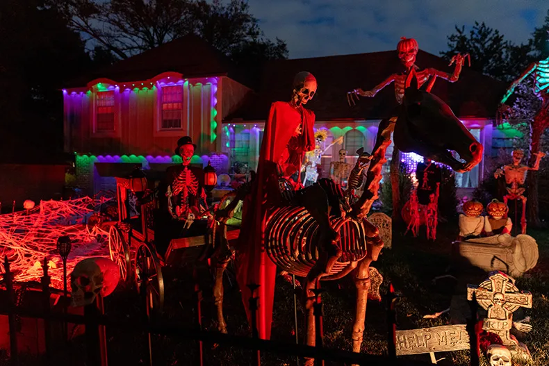 Skeletons cover the lawn of a home near West 99th Terrace and Connell Drive in Overland Park.