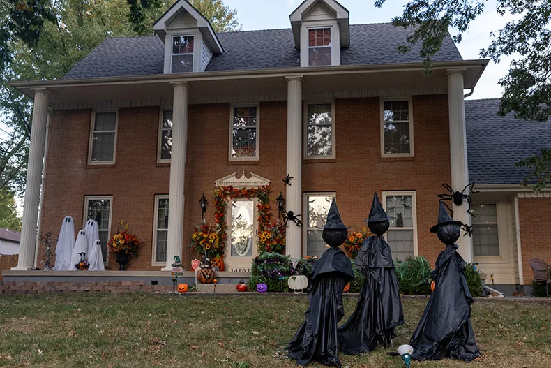 Witches and ghosts guard a home on the corner of South Village Drive and West 146th Street in Olathe.
