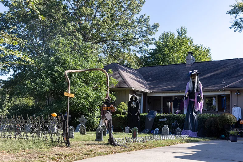 Trick or treaters are encouraged to enter a graveyard outside of a home on the corner of Roe Avenue and West 66th Terrace in Prairie Village.