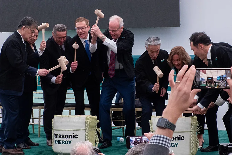 Kansas and Panasonic leaders perform a traditional Japanese ceremony called Kagami-biraki, where a sake barrel is opened with mallets, during a grand opening event in June 2025. The ceremony symbolizes opening the door to happiness, unity and prosperity.