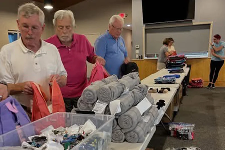 The Lenexa Rotary Club partnered with a Shawnee Mission Northwest club to fill 210 care packages for foster children. Photo courtesy Lenexa Rotary Club.