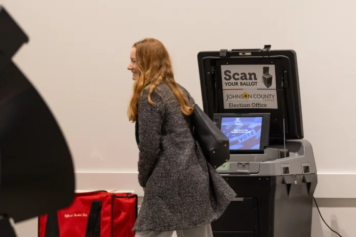 A voter casts her ballot on Election Day at the Johnson County Arts & Heritage Center in Overland Park.