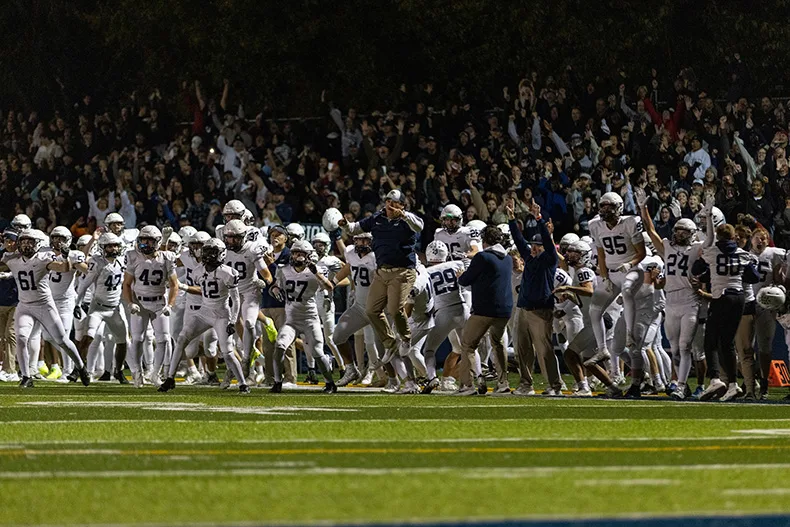 The Mill Valley sideline reacts to a failed two-point conversion by Saint Thomas Aquinas at the end of the game.
