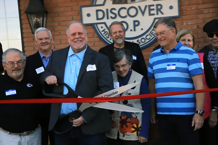 Overland Park Historical society members and Executive Director Brad Moore cute the ribbon the their new home in downtown Overland Park.