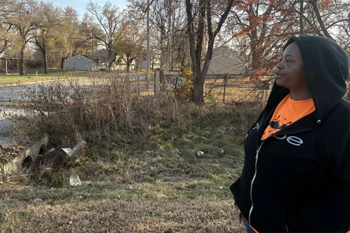 Candice Montgomery stands outside the closed Aspen Place apartment complex in Gardner, Kansas. She is one of hundreds of former residents who were kicked out of their homes when Gardner officials condemned the property.